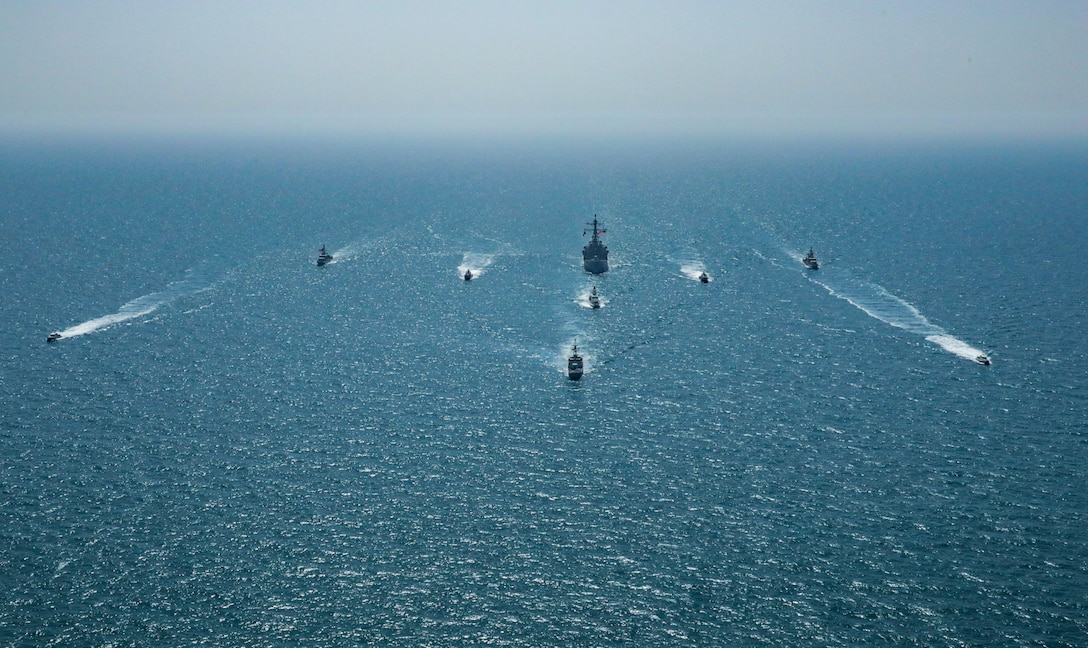 ARABIAN GULF (April 7, 2021) – Royal Bahrain Naval Force fast attack craft RBNS Abdul Rahman Al-fadel (P 22), Bahrain Coast Guard response boats Hawar 5 and Hawar 4, U.S. Navy guided-missile destroyer USS Mahan (DDG 72), patrol coastal ships USS Squall (PC 7) and USS Hurricane (PC 3), U.S. Coast Guard patrol boat USCGC Adak (WBP 1333) and two Mark VI patrol boats operate in formation during exercise Neon Defender in the Arabian Gulf, April 7. Neon Defender 21 is a bilateral maritime exercise between the U.S. and Bahrain, designed to enhance interoperability and readiness, fortify military-to-military relationships and advance operational capabilities, allowing participating naval forces to effectively develop the necessary skills to address threats to regional security, freedom of navigation and the free flow of commerce. (Army Photo by Spc. Evens Milcette Jr.)