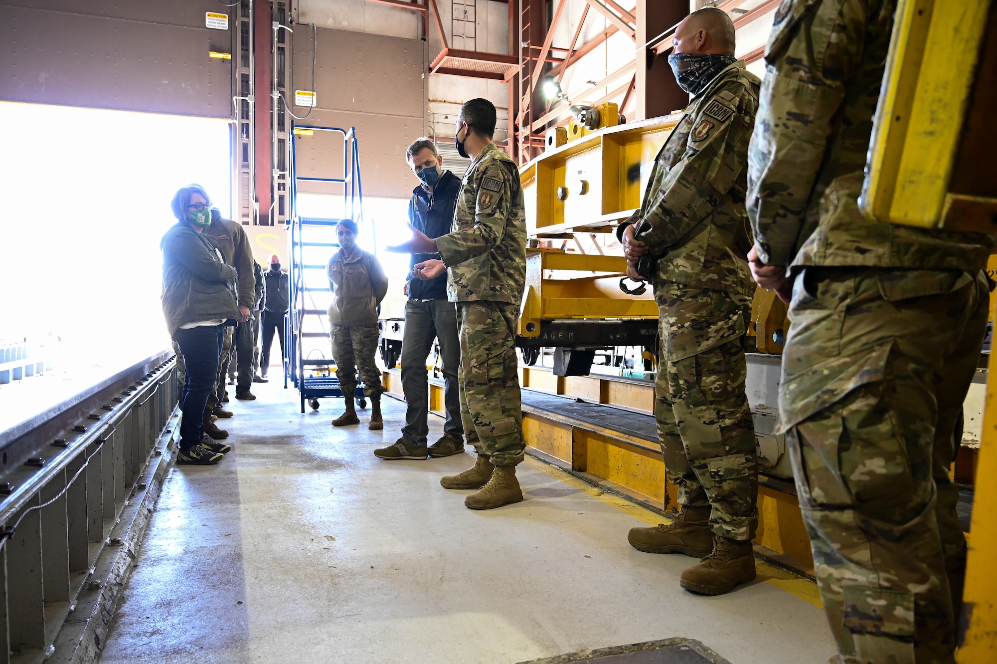 U.S. Rep. Blake Moore and others standing in a missile transfer facility.