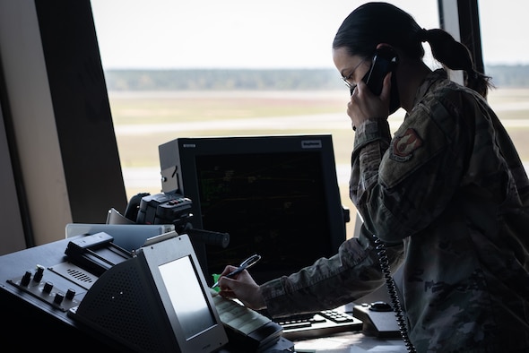 Civilian man observes screen displaying flight patterns.