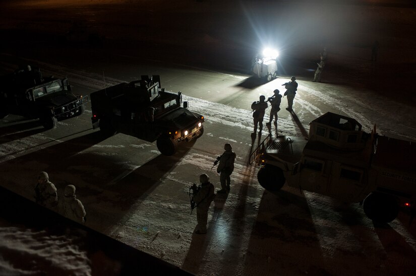 Airmen from the 5th Security Forces Squadron Delta Flight perform a security sweep during a recapture exercise in the Weapons Storage Area at Minot Air Force Base, N.D. Jan. 30, 2014. During every shift, Airmen perform a minimum of one exercise in the WSA to ensure they know the proper procedures should a crisis arise. (U.S. Air Force photo/Senior Airman Stephanie Sauberan)