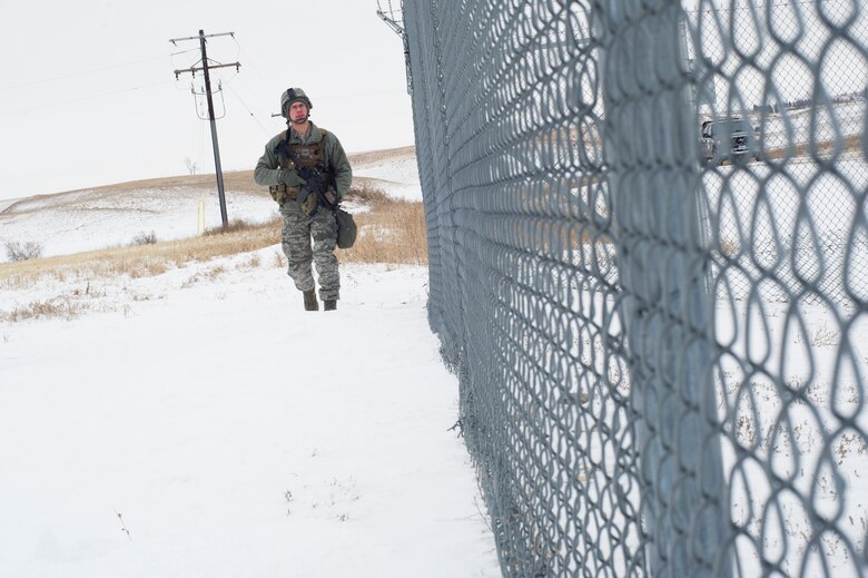 Airman 1st Class Patrick Boylan, 91st Missile Security Forces response force leader, performs an outer perimeter check on a launch facility in North Dakota, Feb. 12, 2015. Security forces have several layers of cold weather gear for warmth. (U.S. Air Force photo/Senior Airman Brittany Y. Bateman)