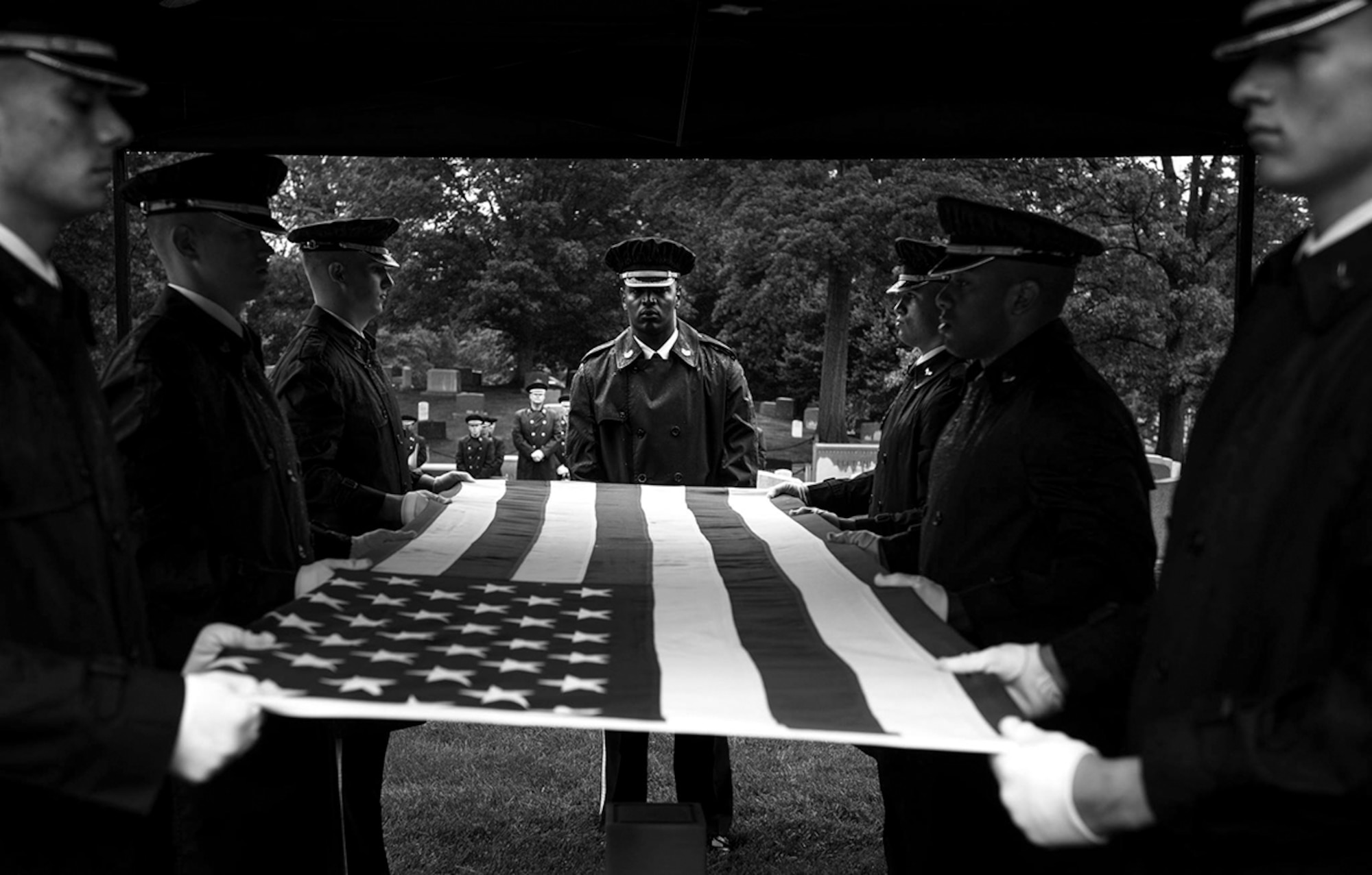 Airmen with the United States Air Force Honor Guard prepare to fold the American flag during a funeral honoring the late Col. Noel Elmer Hoblit on May 21, 2015 at Arlington National Cemetery. Col. Hoblits two sons, U.S. Air Force Col. Jerry Hoblit (ret.) and Lt. Col. (ret.) Fred Hoblit, remembered the life of their father during a funeral with family and friends at the Arlington National Cemetery. Col. Hoblit perished in an airplane crash near Alaska on Nov. 22, 1952. Personnel assigned to the Joint Recovery Prisoner of War Missing In Action team, located, identified and returned Col. Hoblit to his family for a ceremony with honor.