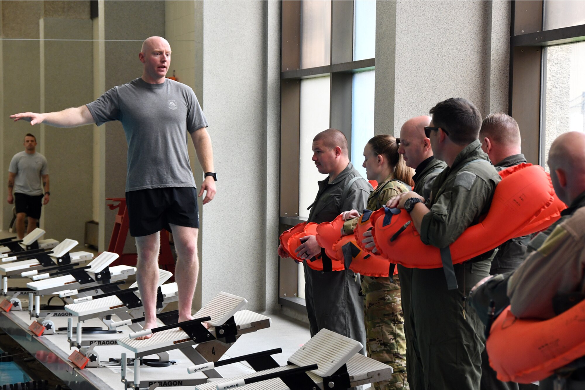 Master Sgt. Zach Angel, a Survival, Evasion, Resistance and Escape specialist assigned to the 910th Operations Support Squadron, briefs a group of Reserve Citizen Airmen assigned to the squadrons of the 910th Operations Group participating in an aircrew water survival refresher training event at Youngstown State University’s Beeghly Natatorium Olympic Swimming Pool, April 11, 2021.