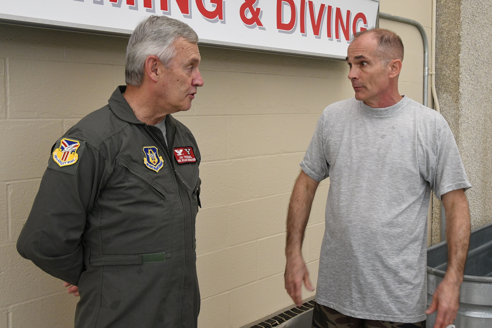 Master Sgt. Phillip Walsh, aircrew flight equipment Non-Commissioned Officer in Charge assigned to the 910th Operations Support Squadron (left), talks with Youngstown State University President Jim Tressel during an aircrew water survival refresher training event at Youngstown State University’s Beeghly Natatorium Olympic Swimming Pool, April 11, 2021.