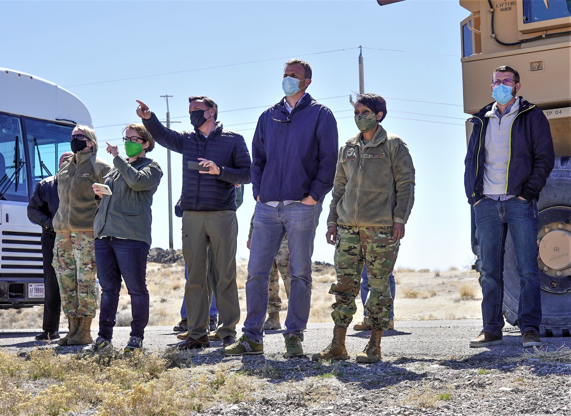 U.S. Rep. Blake Moore (UT-1), congressional staff, and base leadership standing while they observe a controlled detonation.