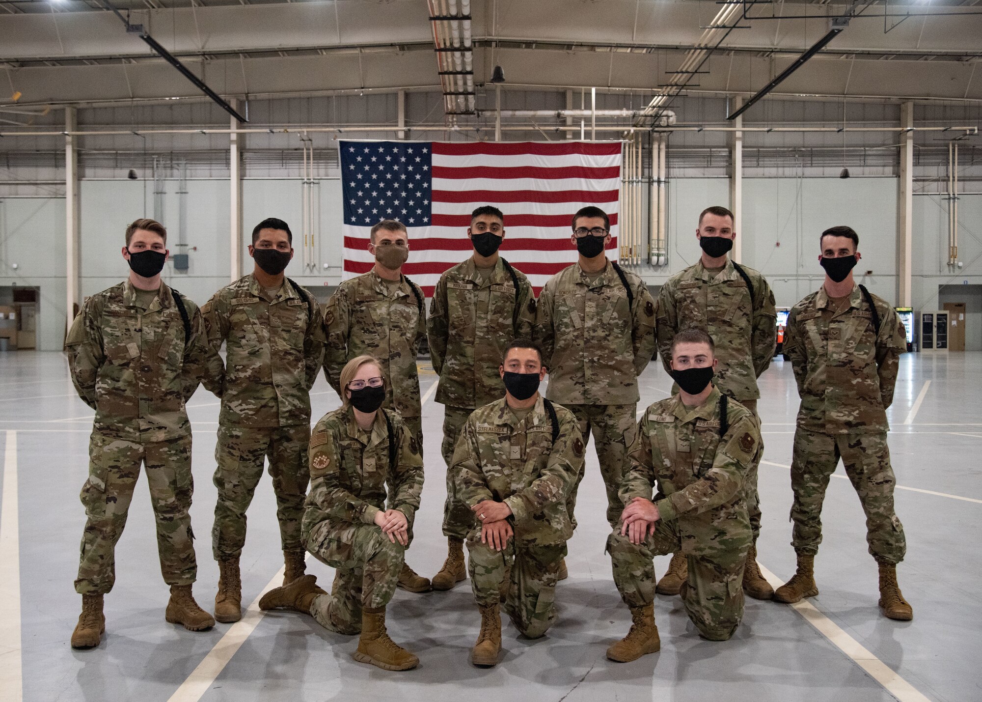 Student drill team members from various squadrons, pose for a photo after participating in a recorded drill routine.