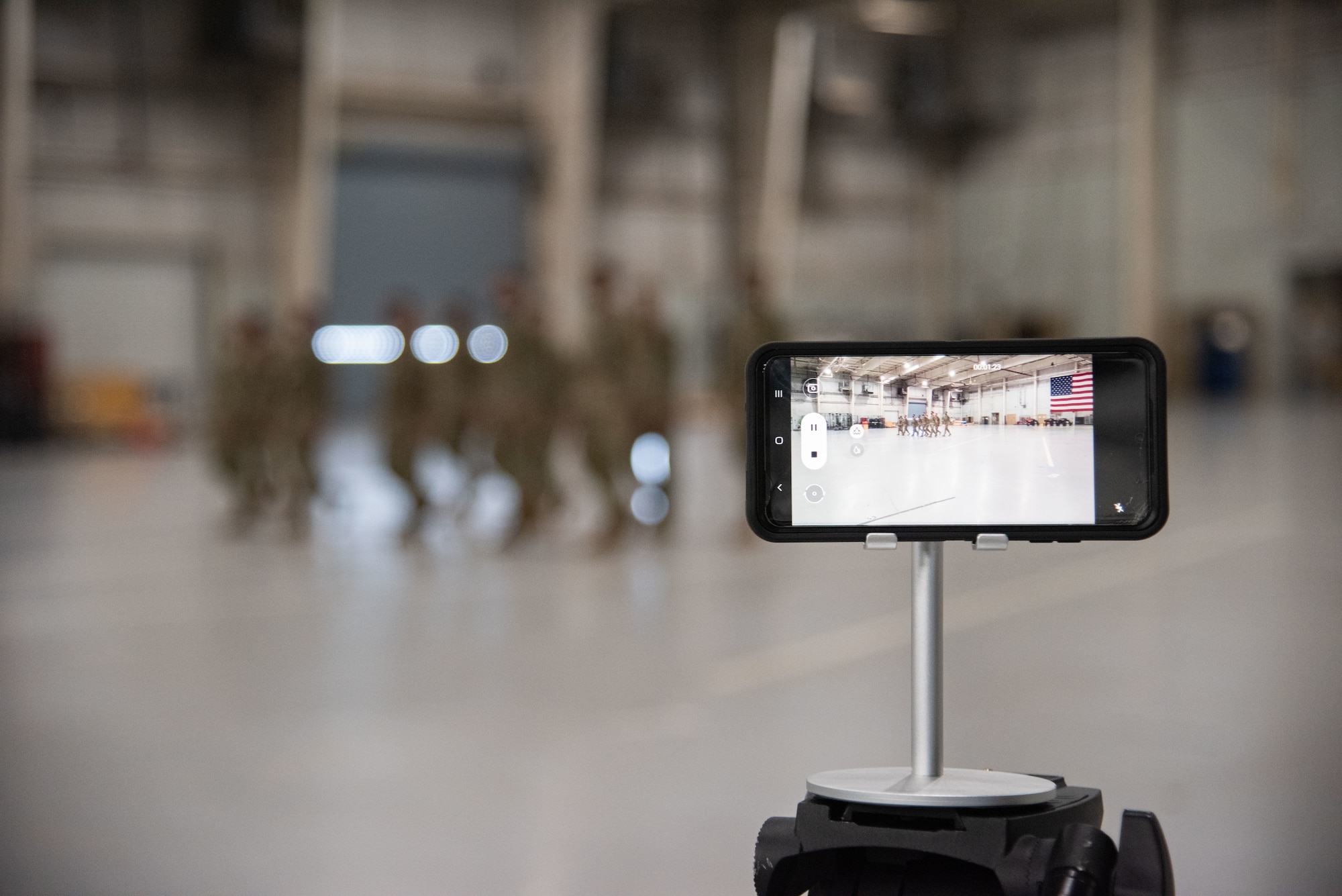 A cellular phone records U.S. Air Force Airmen as they execute drill movements for a drill competition.