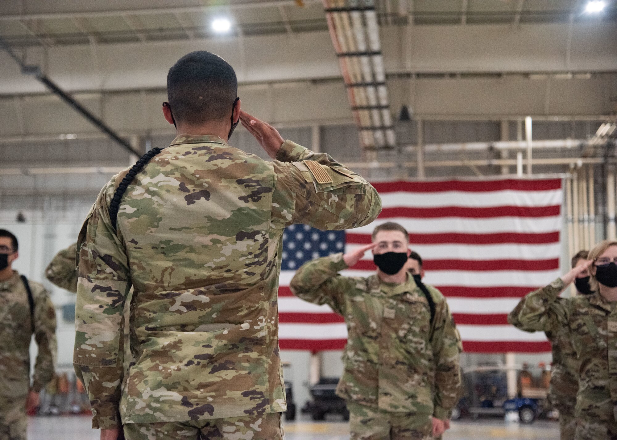 U.S. Air Force Airman 1st Class Jose Delgado, 315th Training Squadron student drill team member, renders a salute along with his fellow Airmen.