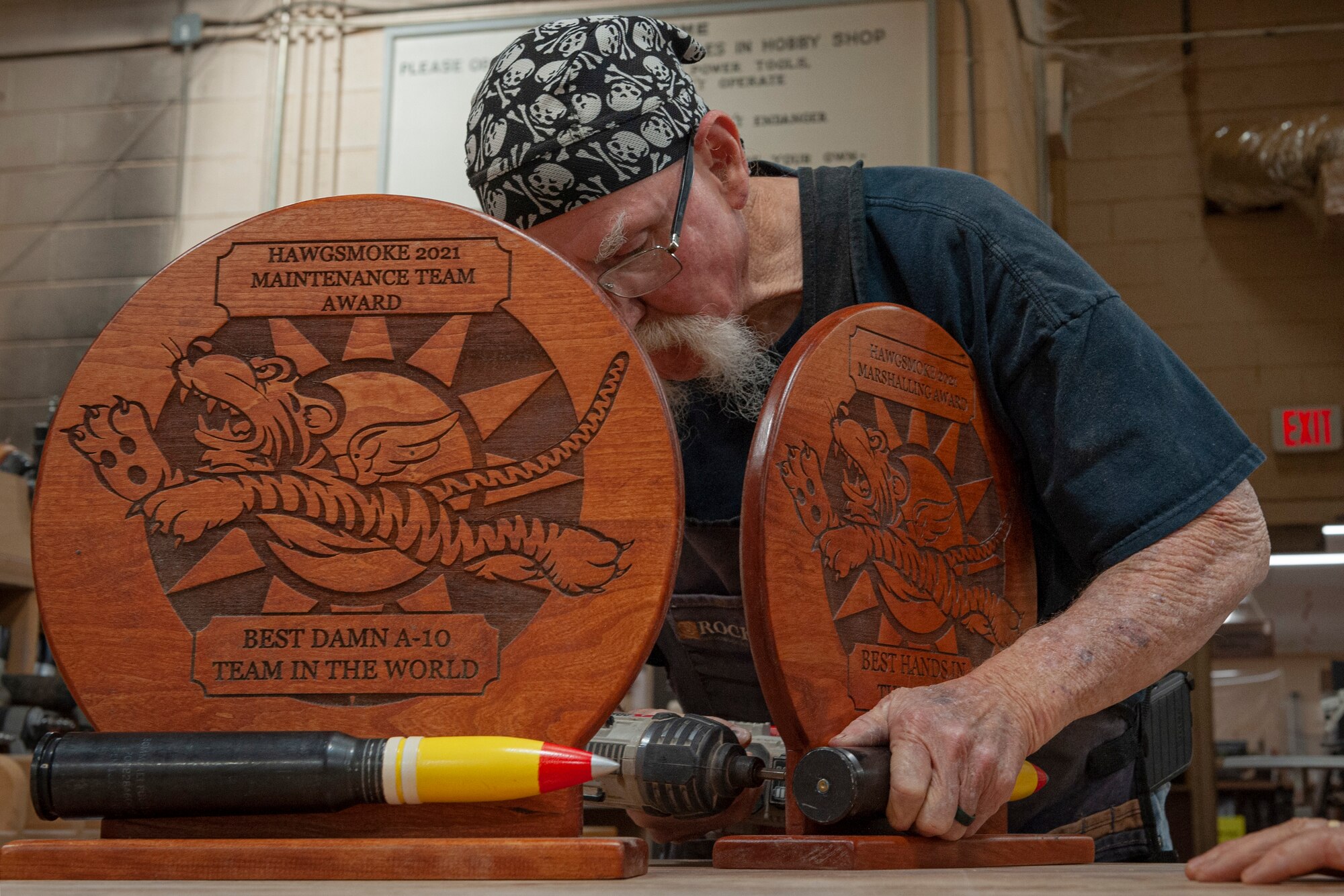 Photo of an Airman assembling an award