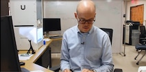 Man reads documents on his desk.