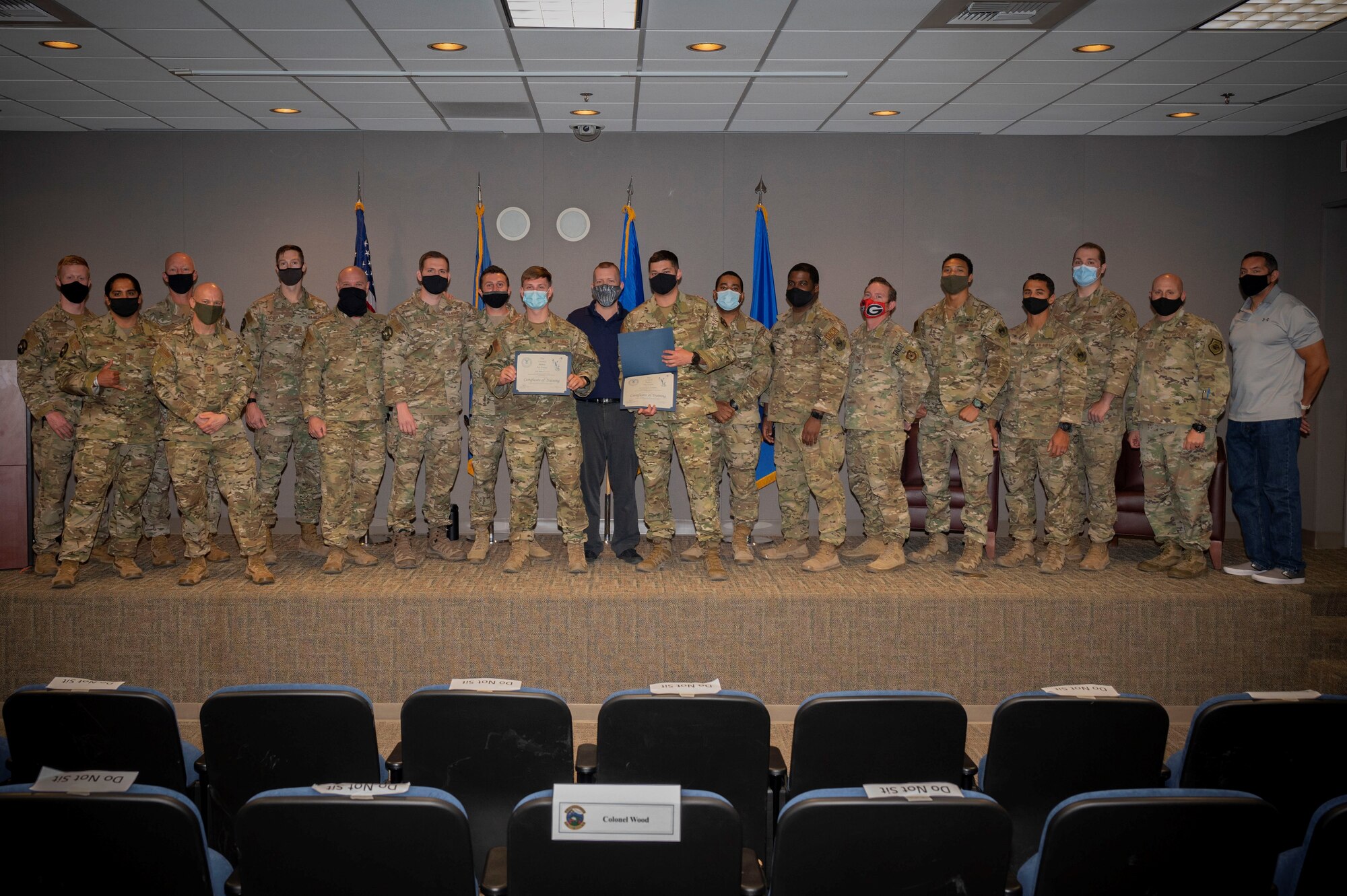 Graduates pose for photo with their instructors.