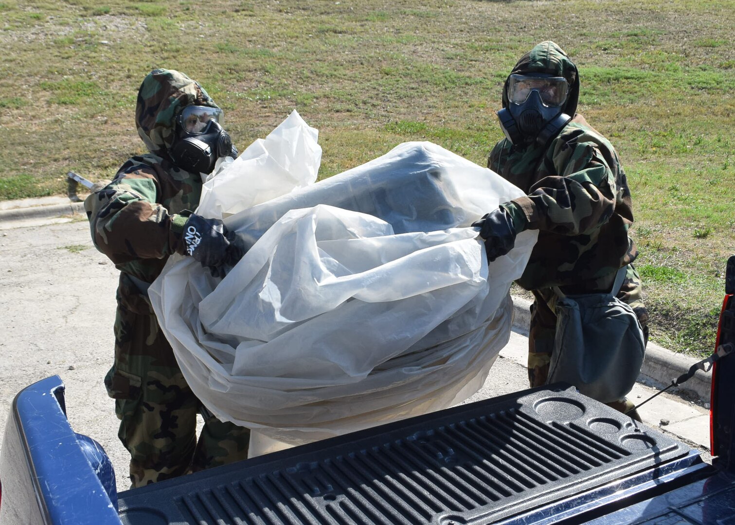 Senior Airman Jennifer Martinez and Senior Airman Ashley Garcia, 433rd Force Support Squadron, load a container onto a truck for transport during a field training exercise, April 10, 2021, at Joint Base San Antonio-Lackland, Texas. The exercise provided Reserve Citizen Airmen familiarity with real-world scenarios they could face in a deployed environment or at home. (U.S. Air Force photo by Tech. Sgt. Mike Lahrman)