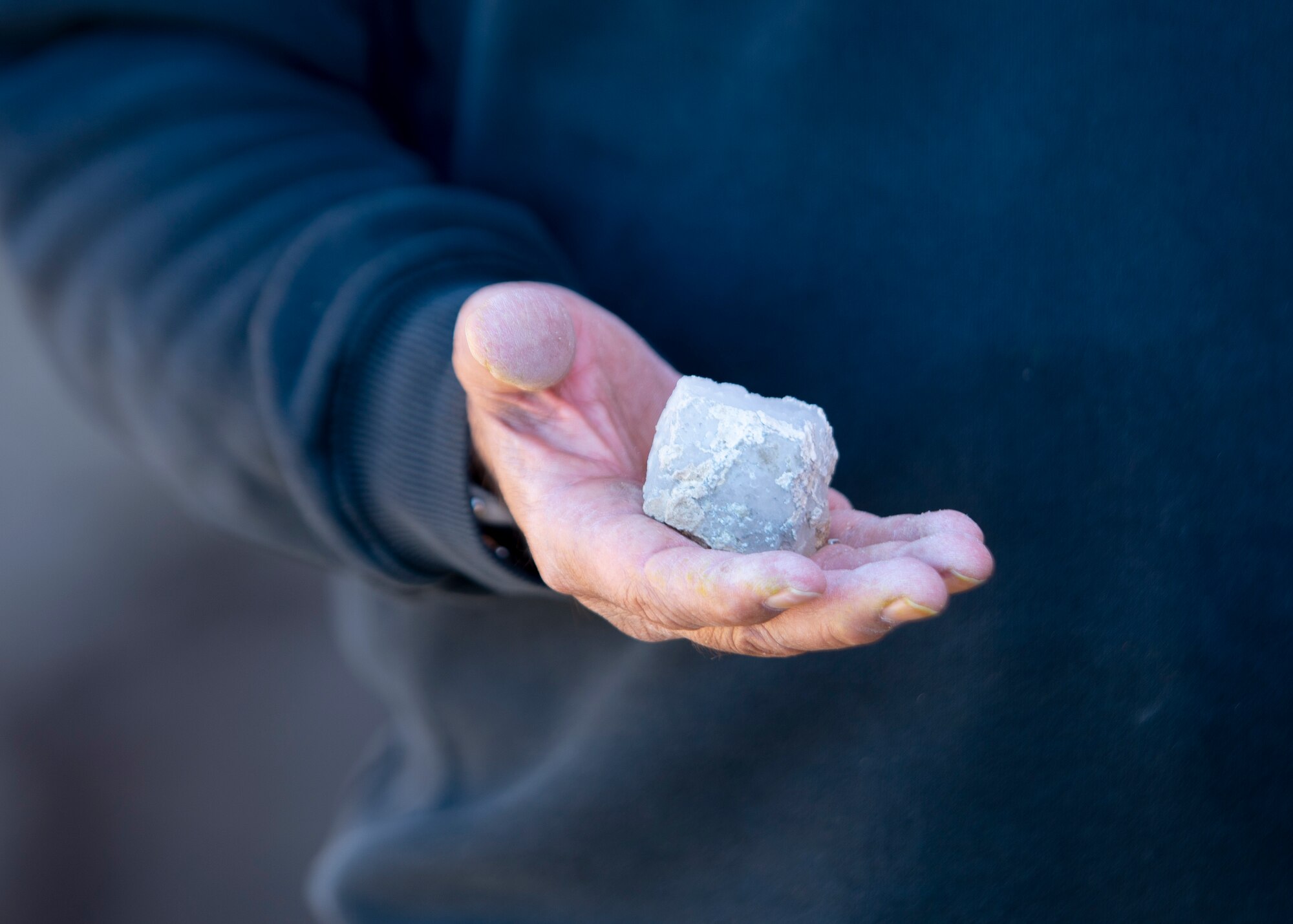 Tribal representative holds a piece of quartz.