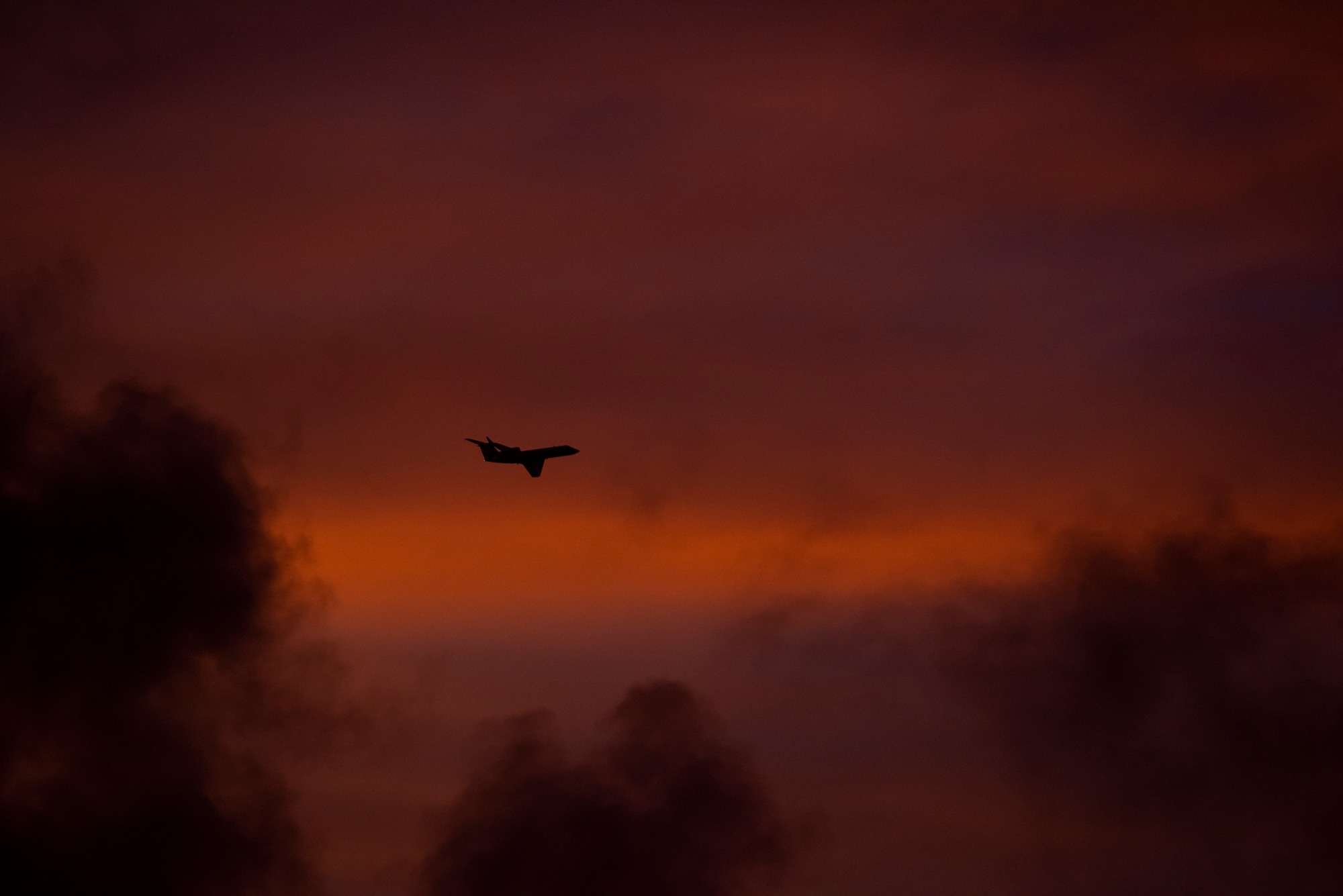 A Gulfstream IV flies into the sunrise