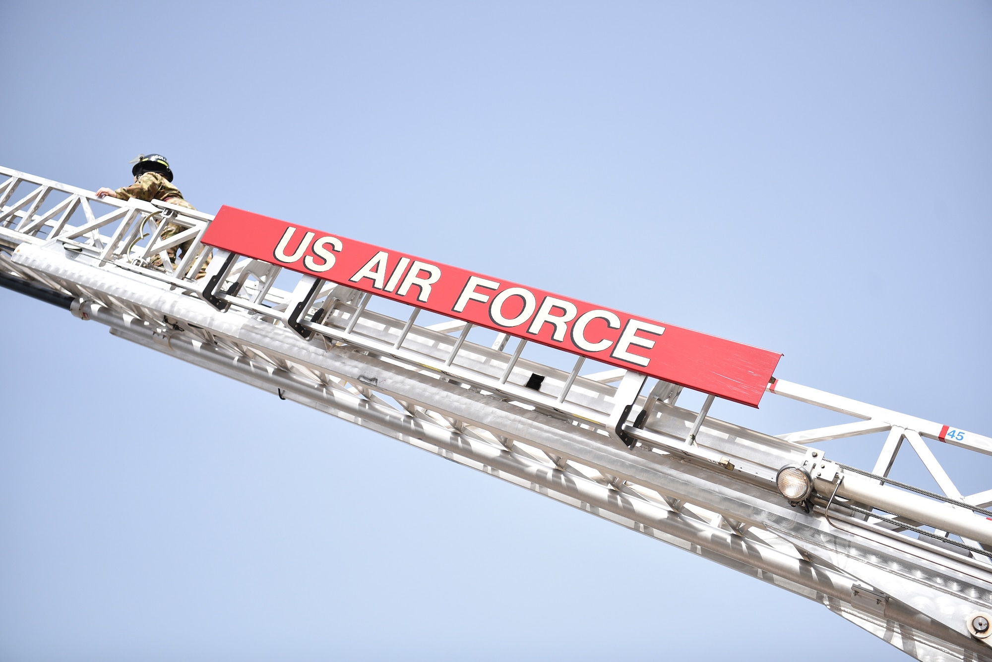 U.S. Air Force Staff Sgt. Journey Collier, a 35th Civil Engineer Squadron firefighter, climbs a fire truck ladder at Misawa Air Base, Japan, March 31, 2021. Collier recently won the Air Force Military Firefighter of the Year award, and credits teamwork as the reason for her success. (U.S. Air Force photo by Airman 1st Class Joao Marcus Costa)