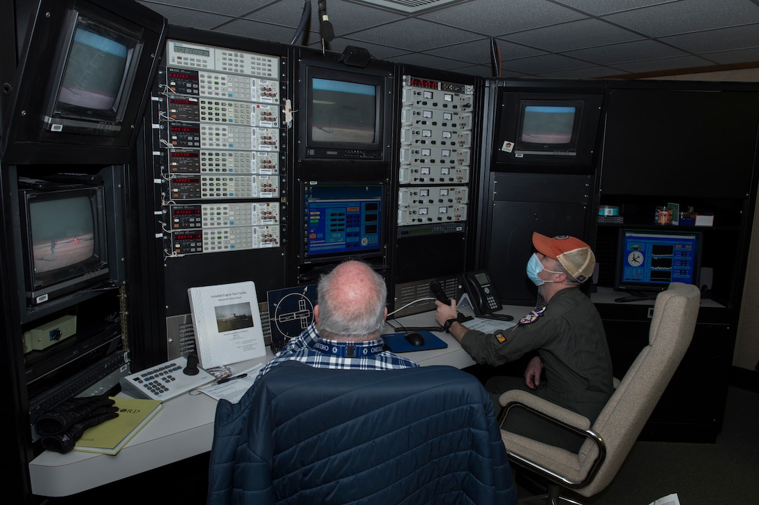 Gary Peddecord, 812th Aircraft Instrumentation Test Squadron, and Capt. Cameron Clites, Air Force Test Pilot School class 20-B student, monitor an engine test run at the Installed Engine Test Facility Horizontal Thrust Stand control room at Edwards Air Force Base, California, March 5. (Air Force photo by Joshua Miller)