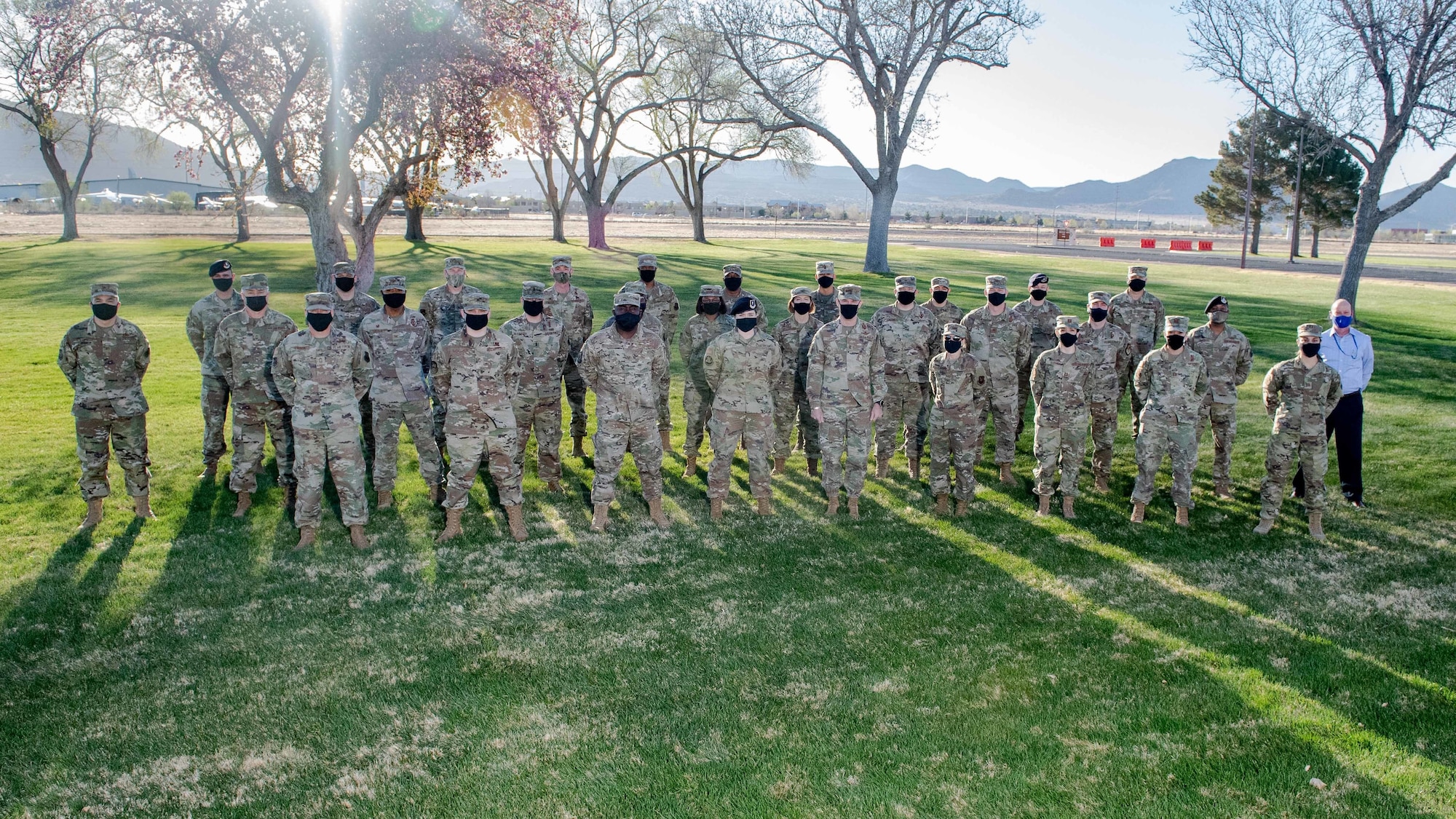U.S. Air Force officers pose for group photo outdoors.
