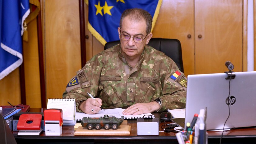 A military general signs a document