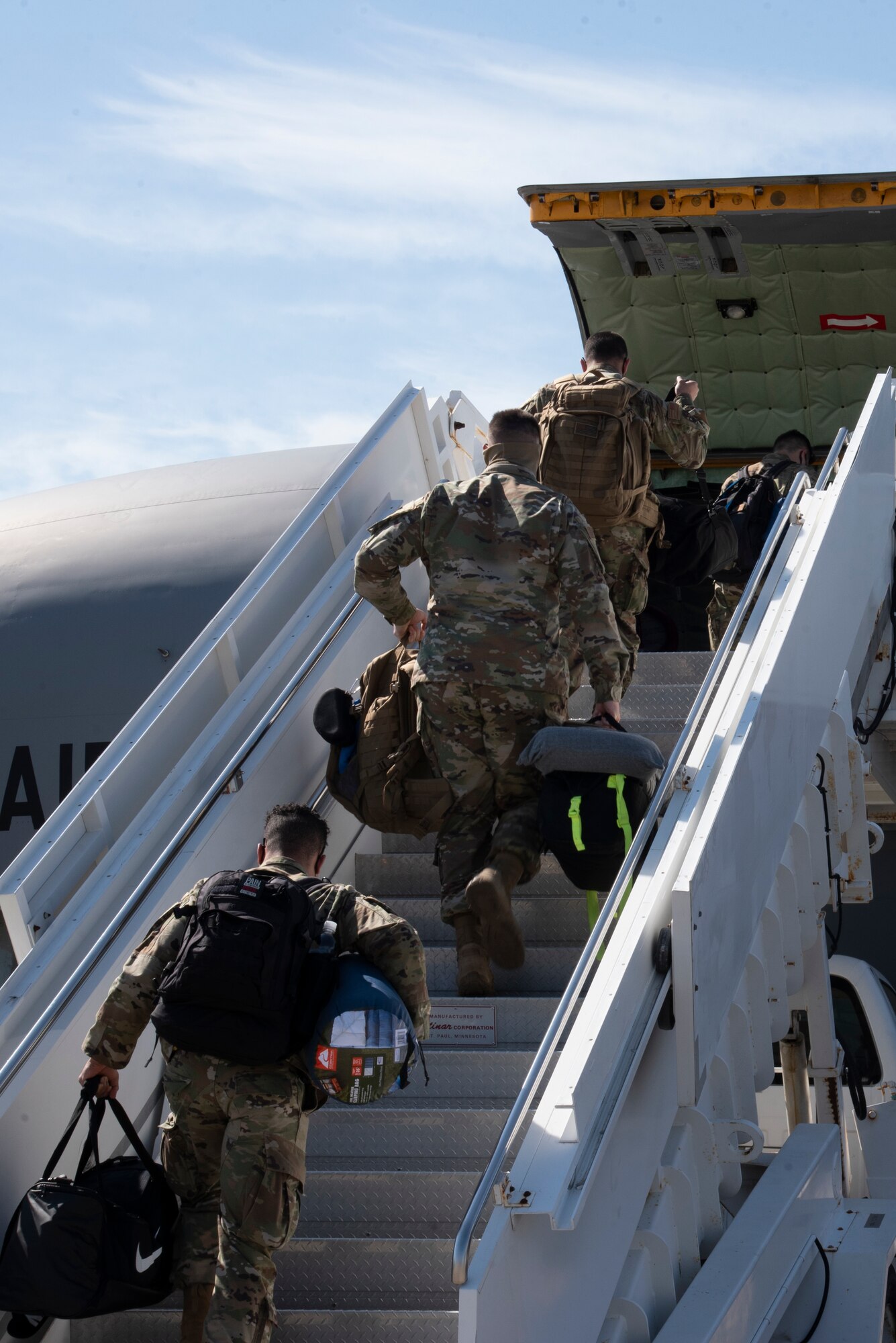 Team MacDill Airmen climb a set of air stairs to board a KC-135 Stratotanker aircraft on the flight line, April 8, 2021 at MacDill Air Force Base, Fla.