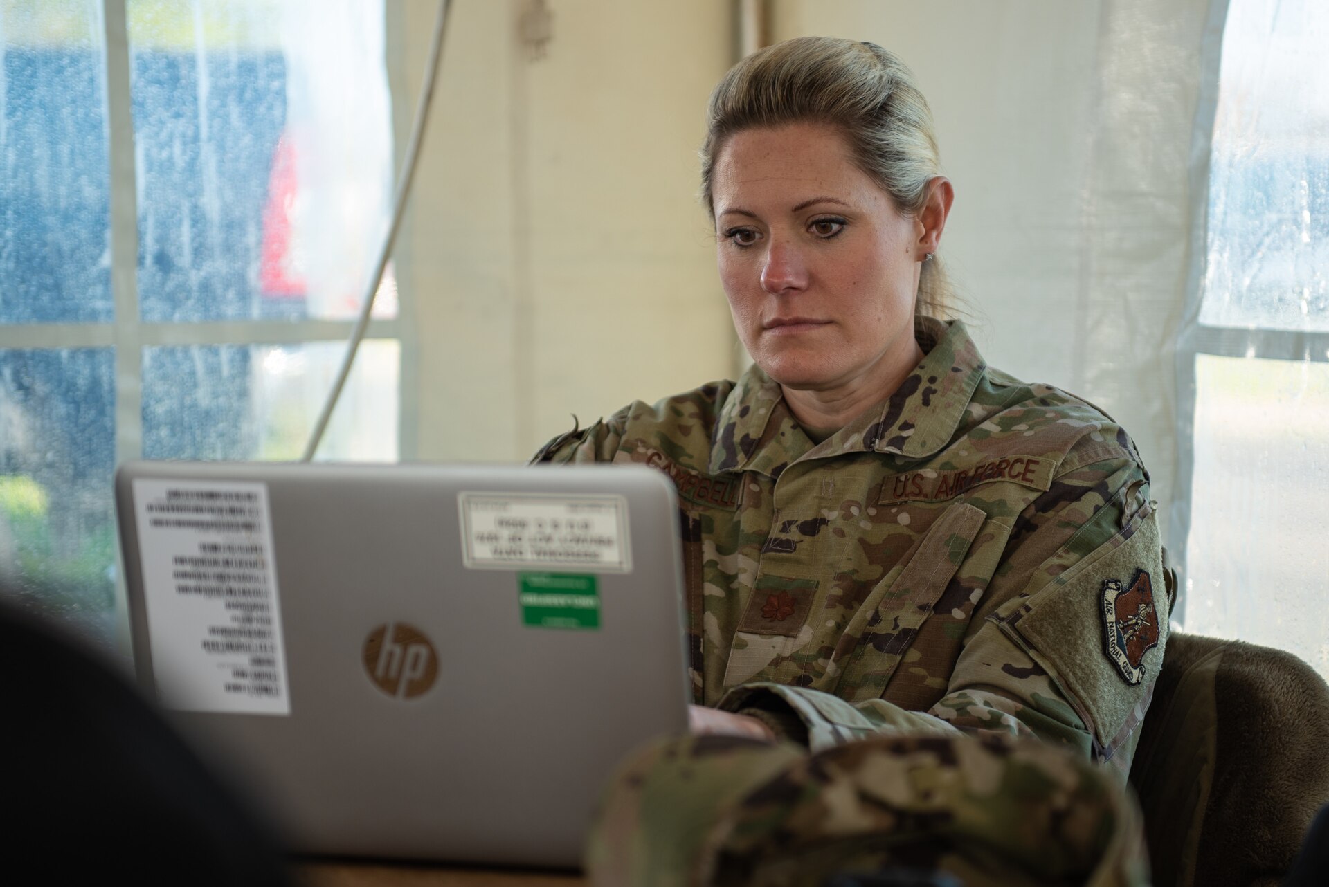 U.S. Air Force Maj. Tiffany Campbell of the Kentucky Air National Guard prepares a situation report at Kentucky’s largest drive-through COVID-19 vaccination clinic at Cardinal Stadium in Louisville, Ky., April 12, 2021. More than 30 Soldiers and Airmen from the Kentucky Army and Air National Guard are providing direct support to the clinic, which can vaccinate up to 4,000 patients a day. (U.S. Air National Guard photo by Dale Greer)
