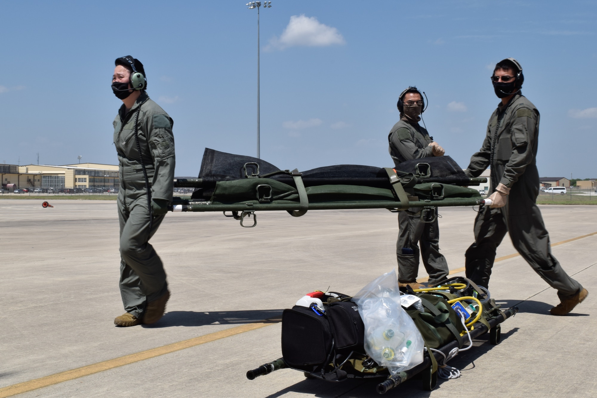 The 433rd Aeromedical Evacuation Squadron reserve citizen Airmen load medical equipment on a C-130 J Hercules during a joint training exercise at Joint Base San Antonio-Lackland, Texas, April 8, 2021. The medical flight crew simulated the loading of medical equipment to assist in contaminated patient transport. (U.S. Air Force photo by Senior Airman Brittany Wich)