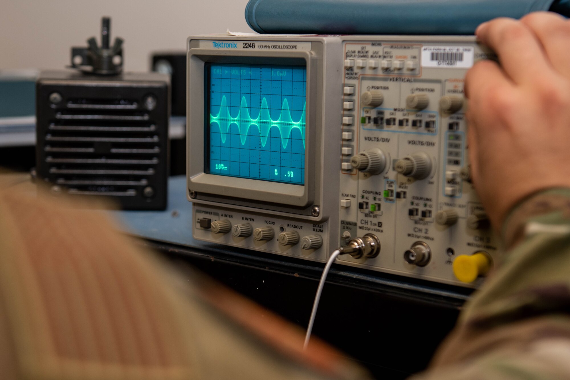 An Airman works with a piece of radio equipment