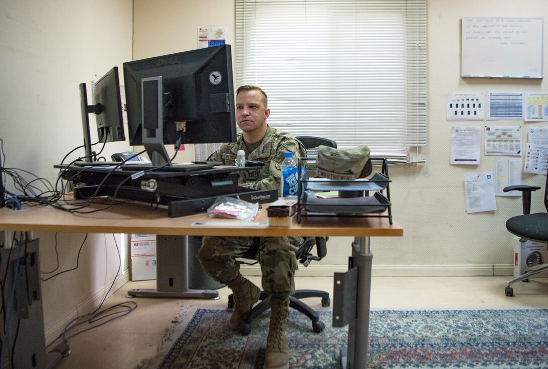 a man works at a computer at a desk