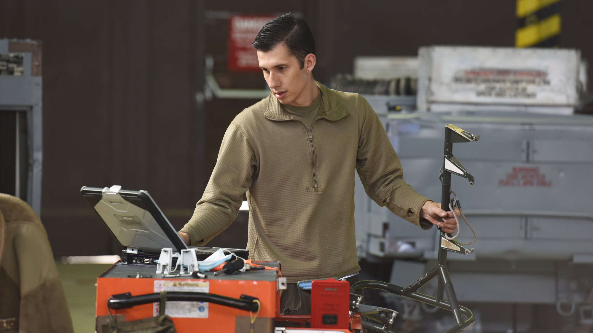 U.S. Air Force Staff Sgt. Patrick Montoya, 52nd Maintenance Squadron Aircraft Inspection Craftsman, reviews technical orders before working with a fire control radar antenna handling device during a radar replacement. The 52nd Maintenance Squadron Maintenance Flight won the 52nd Fighter Wing Flight Safety Award for the fourth quarter of 2020 and also for the first quarter of 2021. (U.S. Air Force photo by Tech. Sgt. Tony Plyler)