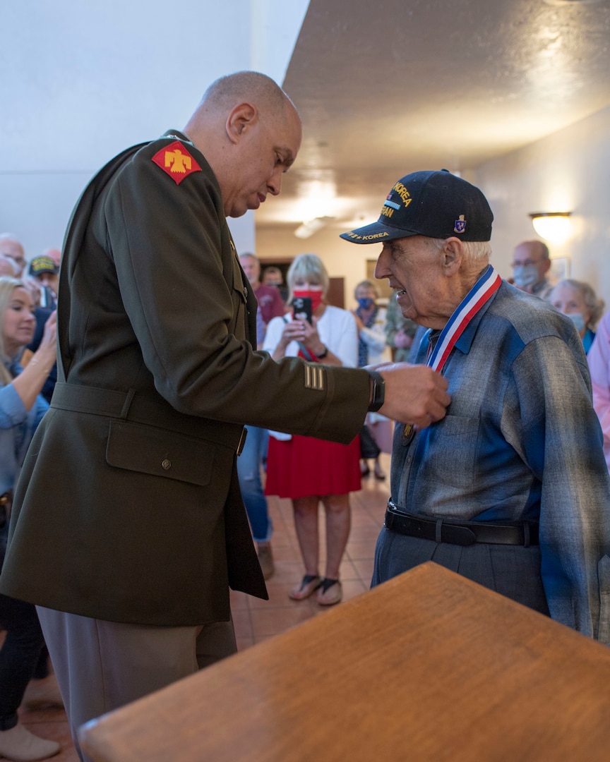 Maj. Gen. Michael Thompson, adjutant general for Oklahoma, presents the Thunderbird Medal to Lt. Col. (Ret.) Oren L. Peters, World War II and Korean War Veteran from the renowned 45th Infantry Division, Saturday, April 10, 2021 in Edmond, Oklahoma. The Thunderbird Medal is the Oklahoma National Guard’s highest award presented to a civilian. (Oklahoma National Guard photo by Lt. Col. Geoff Legler)