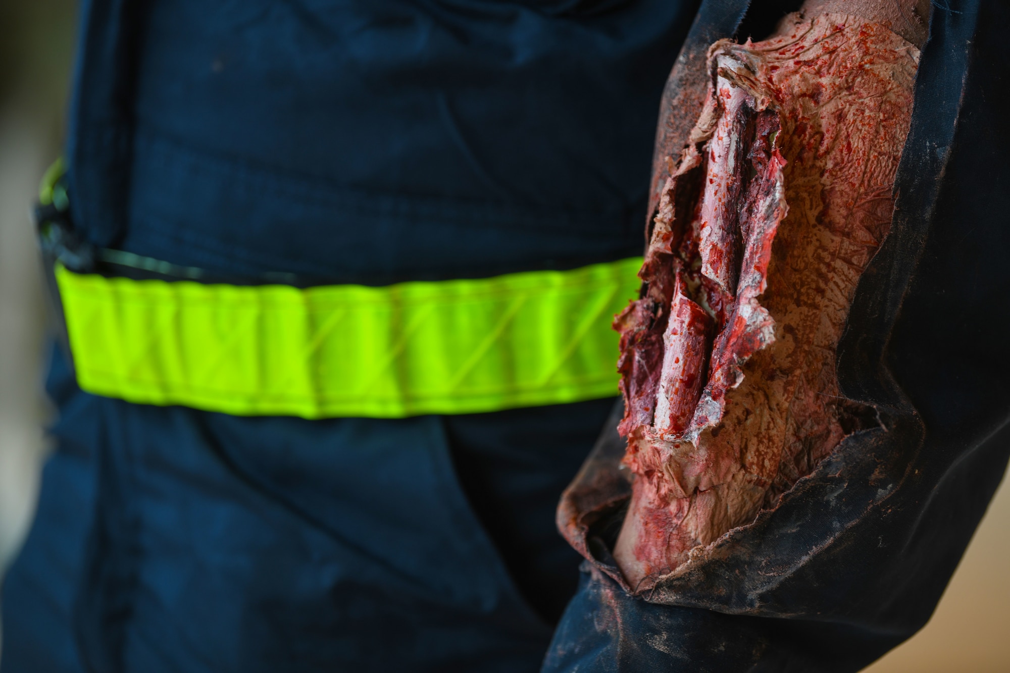 Airman 1st Class Christian DeJesus, 31st Maintenance Squadron aerospace ground equipment apprentice, models a simulated wound during a base defense readiness exercise at Aviano Air Base, Italy, April 12, 2021. The exercise provided Airmen the opportunity to train for real-world situations during simulated scenarios. (U.S. Air Force photo by Senior Airman Ericka A. Woolever)