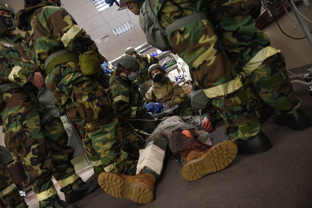 U.S. Airmen from the 31st Fighter Wing treat a patient with a simulated fractured leg during a base defense readiness exercise at Aviano Air Base, Italy, April 12, 2021. The exercise provided Airmen the necessary training to ensure proper readiness in the event of real-world, medical emergencies. (U.S. Air Force photo by Senior Airman Ericka A. Woolever)