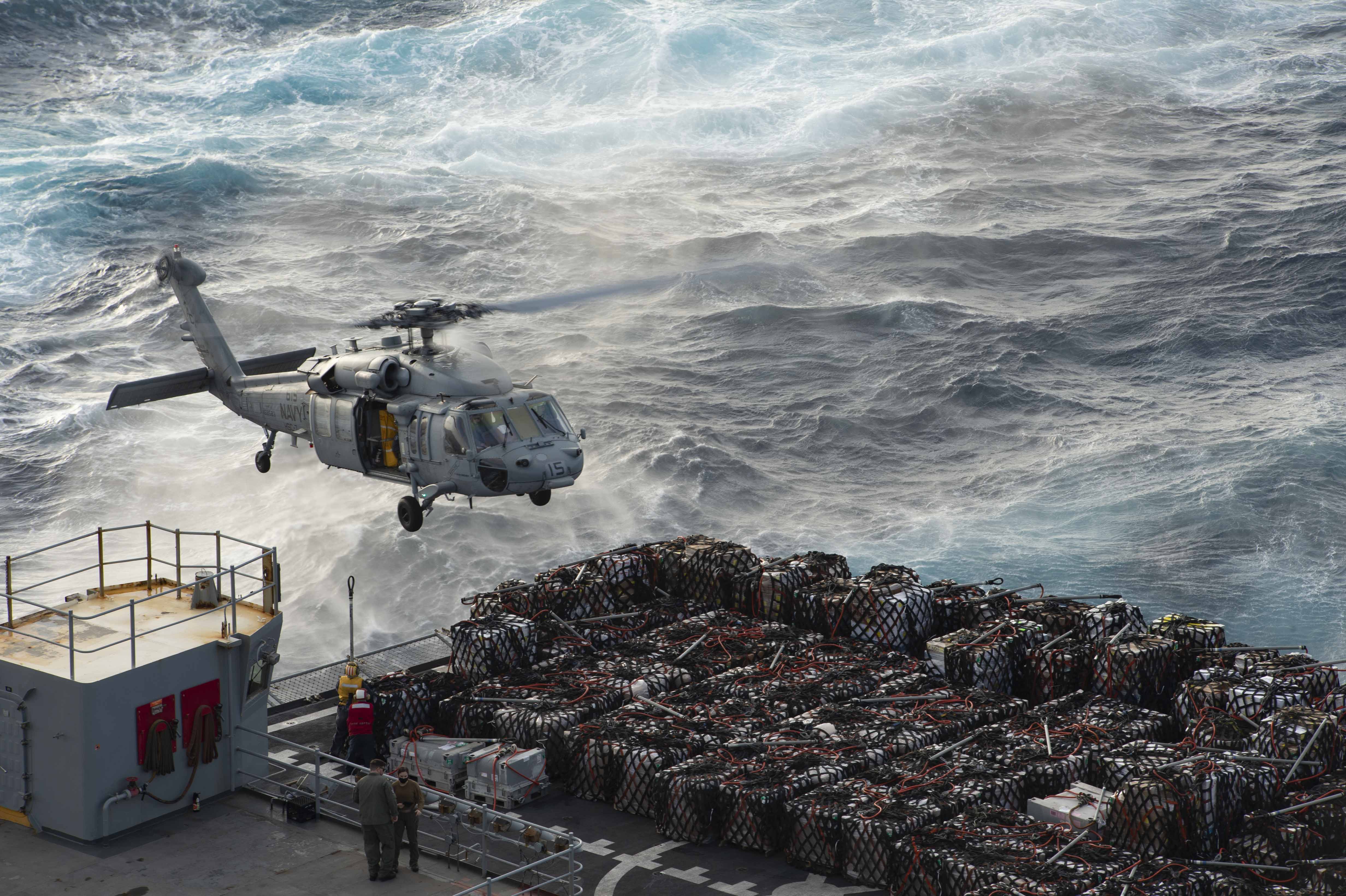 210307-N-YD547-2074 ATLANTIC OCEAN (March 7, 2021) An MH-60S Sea Hawk, attached to the "Dusty Dogs" of Helicopter Sea Combat Squadron (HSC) 7, transports supplies from the fast-combat support ship USNS Arctic (T-AOE 8) to the Nimitz-class aircraft carrier USS Dwight D. Eisenhower (CVN 69), during a vertical-replenishment in the Atlantic Ocean, March 7, 2021. The IKE Carrier Strike Group is on a scheduled deployment in the U.S. Sixth Fleet area of operations in support of U.S. national interests and security in Europe and Africa. (U.S. Navy photo by Mass Communication Specialist Seaman Trent P. Hawkins/Released)