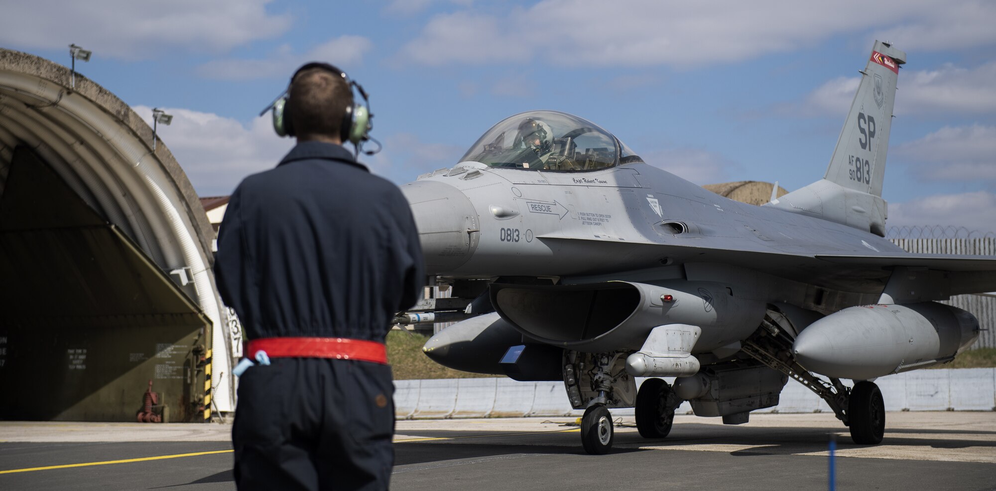 A U.S. Air Force crew chief from the 52nd Maintenance Squadron prepares to launch an F-16 Fighting Falcon during exercise Point Blank 21-02 at Spangdahlem Air Base, Germany, April 9, 2021. More than 50 aircraft from various participating NATO units flew during the exercise over the North Sea. (U.S. Air Force photo by Senior Airman Ali Stewart)