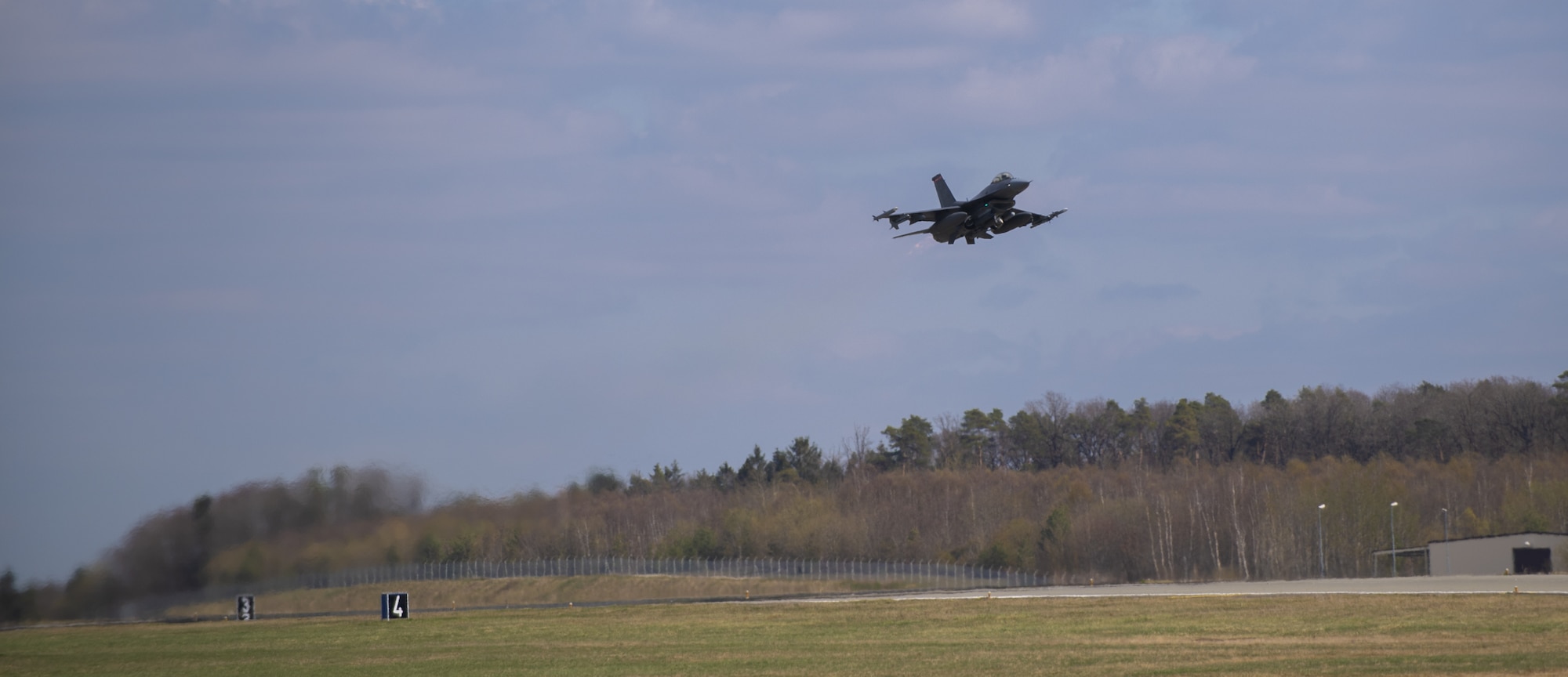 An F-16 Fighting Falcon assigned to the 52nd Fighter Wing takes off from the runway as part of exercise Point Blank 21-02 at Spangdahlem Air Base, Germany, April 9, 2021. Aircraft from Spangdahlem took part in a multi-day exercise over the North Sea alongside Royal Air Force Lakenheath, England, RAF Mildenhall, Engalnd, Aviano AB, Italy, and the Royal Netherlands Air Force. (U.S. Air Force photo by Senior Airman Ali Stewart)