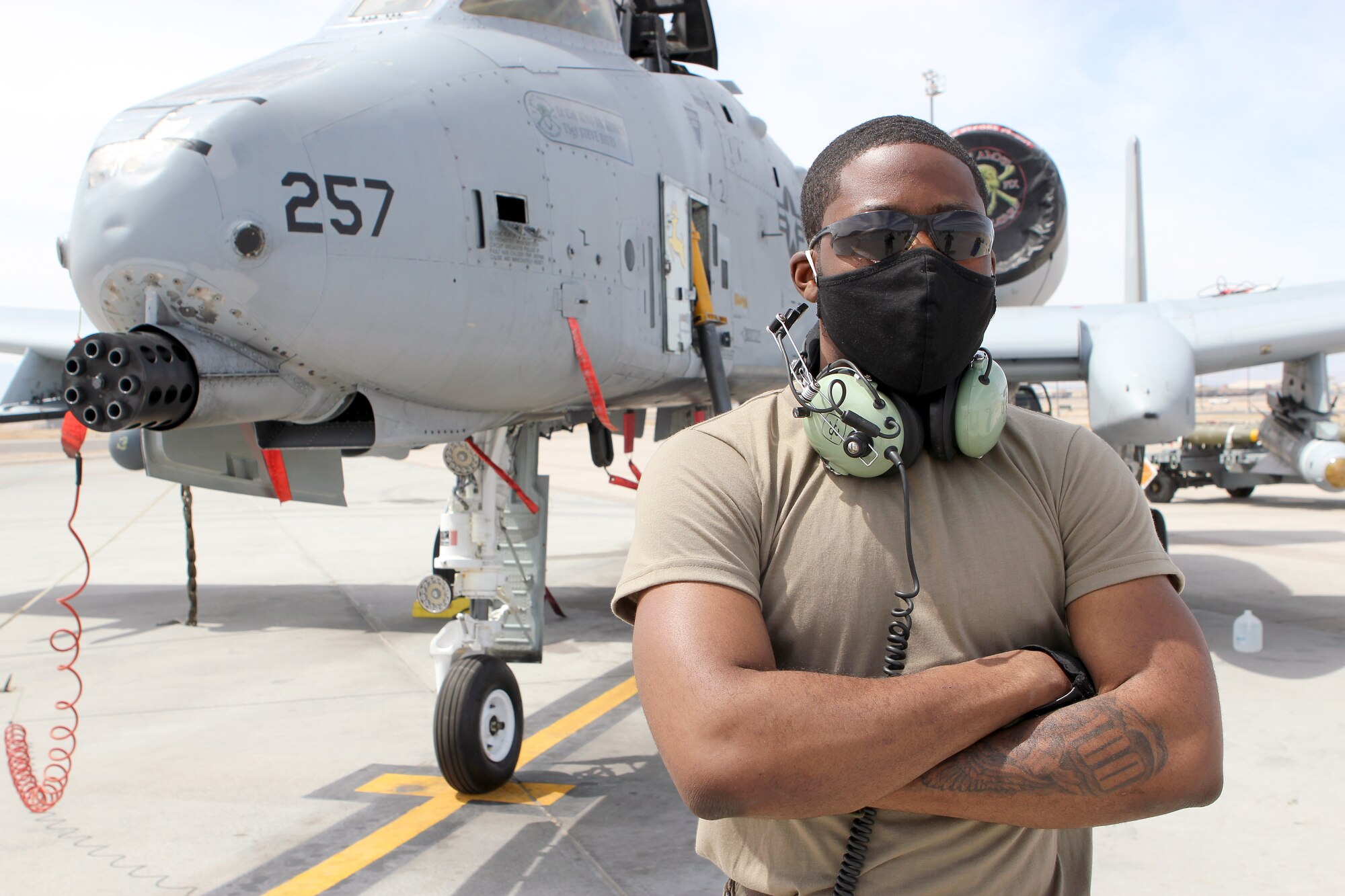 Senior Airman Maurice Starks stand in front of an A-10 Thunderbolt II aircraft while at Nellis Air Force Base, Nev., April 9, 2021. Starks is a weapons loader on the A-10 in the Michigan Air National Guard. He is also a full-time college student and is enrolled in an Air Force ROTC program. (U.S. Air National Guard photo by Master Sgt. Dan Heaton)