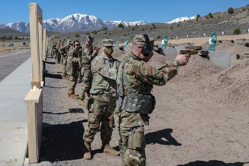 Soldiers shooting pistols at pistol range.
