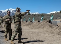 Soldier shooting pistol at range.