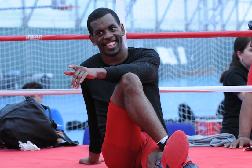 Boxer points finger while sitting in the ring.