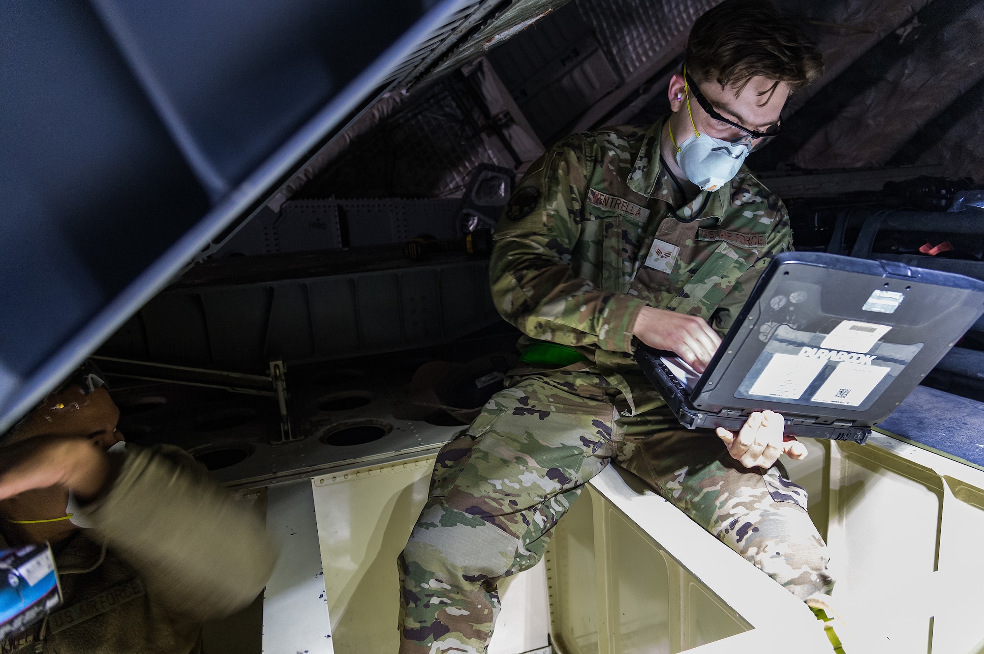 Senior Airman Jack Ventrella, 436th Maintenance Squadron aircraft structural maintenance journeyman, reads technical data prior to making repairs to a C-17 Globemaster III on Dover Air Force Base, Delaware, April 7, 2021. Ventrella and Staff Sgt. Konner Blackwell, 436th MXS aircraft structural maintenance journeyman, repaired the C-17 ramp number 2 bulkhead. (U.S. Air Force photo by Roland Balik)