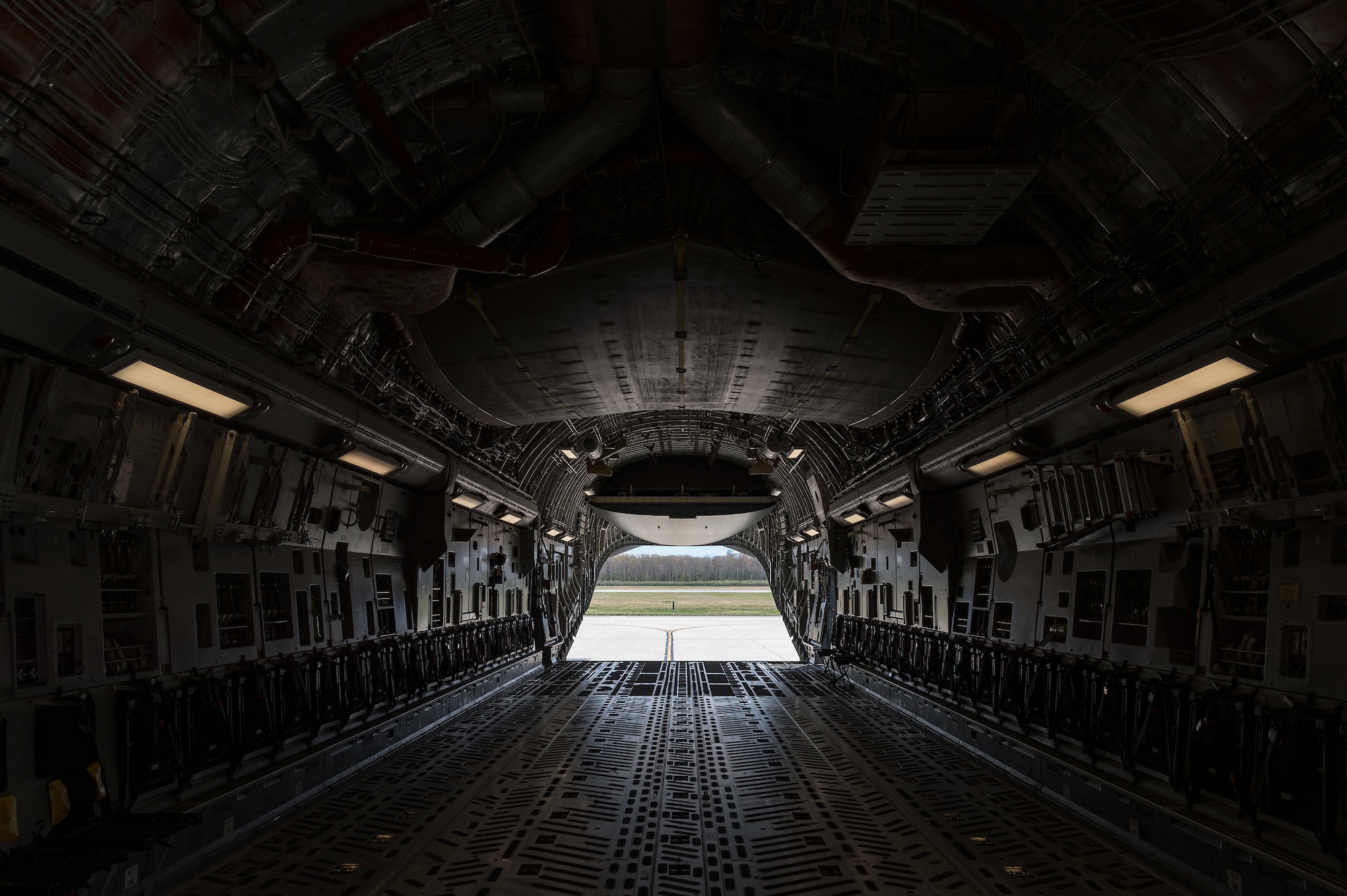 The ramp of a C-17 Globemaster III is positioned in the drive-in mode on Dover Air Force Base, Delaware, April 7, 2021. The C-17 is capable of rapid strategic delivery of troops and all types of cargo to main operating bases or directly to forward bases around the world. (U.S. Air Force photo by Roland Balik)
