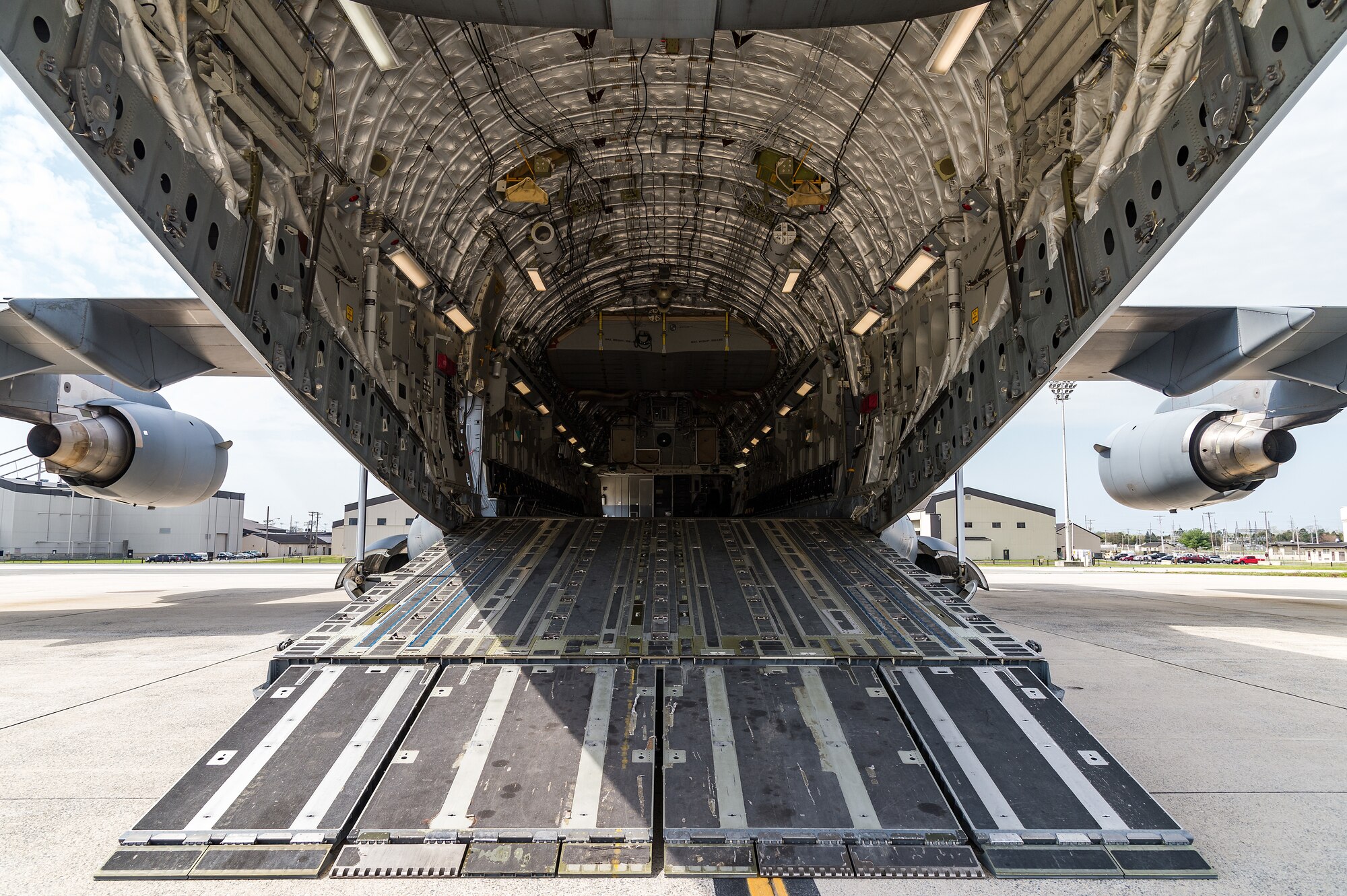 The ramp of a C-17 Globemaster III is positioned in the drive-in mode on Dover Air Force Base, Delaware, April 7, 2021. Cargo is loaded onto the C-17 through a large aft ramp and door system that accommodates virtually all of the Army’s air-transportable equipment such as a 69-ton M1 Abrams main battle tank, armored vehicles, trucks and trailers. (U.S. Air Force photo by Roland Balik)