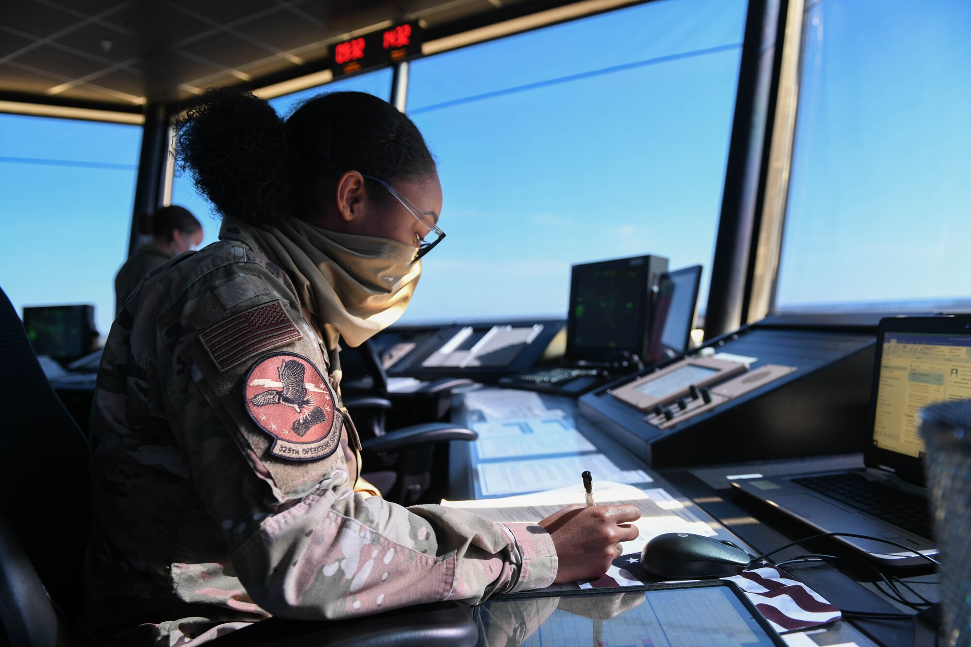 An Airman completes her paperwork in the air traffic control tower at Tyndall Air Force Base.