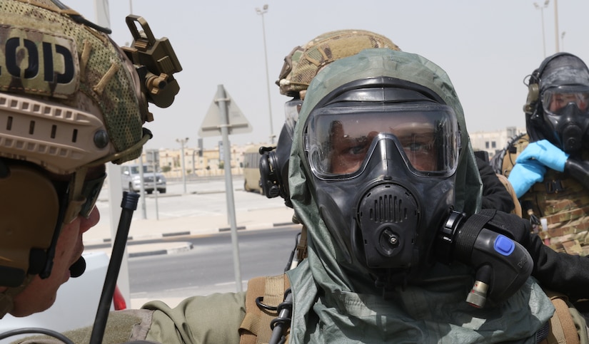 A U.S. Special Operations Forces member dons his protective, respirator mask and chemical resistant suit at a crisis scenario during exercise Invincible Sentry, March 23, 2021, near Doha, Qatar. U.S. Central Command’s annual bilateral exercise allows the U.S. and Qatar to work together toward prevailing against complex regional security challenges. (U.S. Army photo by Staff Sgt. Daryl Bradford, Task Force Spartan Public Affairs)