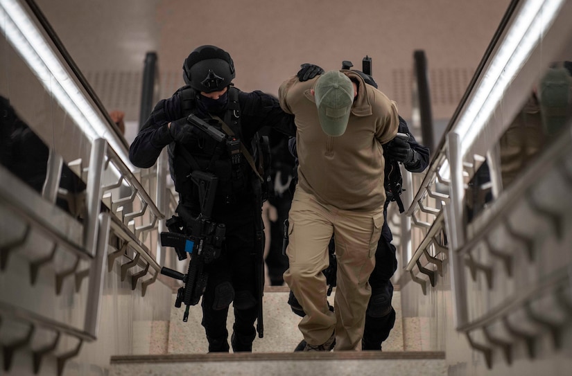 Qatari Special Forces escort a restrained gunman role-player, March 24, 2021, during U.S. Central Command’s crisis response exercise Invincible Sentry in Doha, Qatar. The annual bilateral exercise represents a unique opportunity to train with Qatari partners to practice critical crisis response capabilities. (U.S. Navy photo by Mass Communication Specialist 2nd Class Alex L. Smedegard)