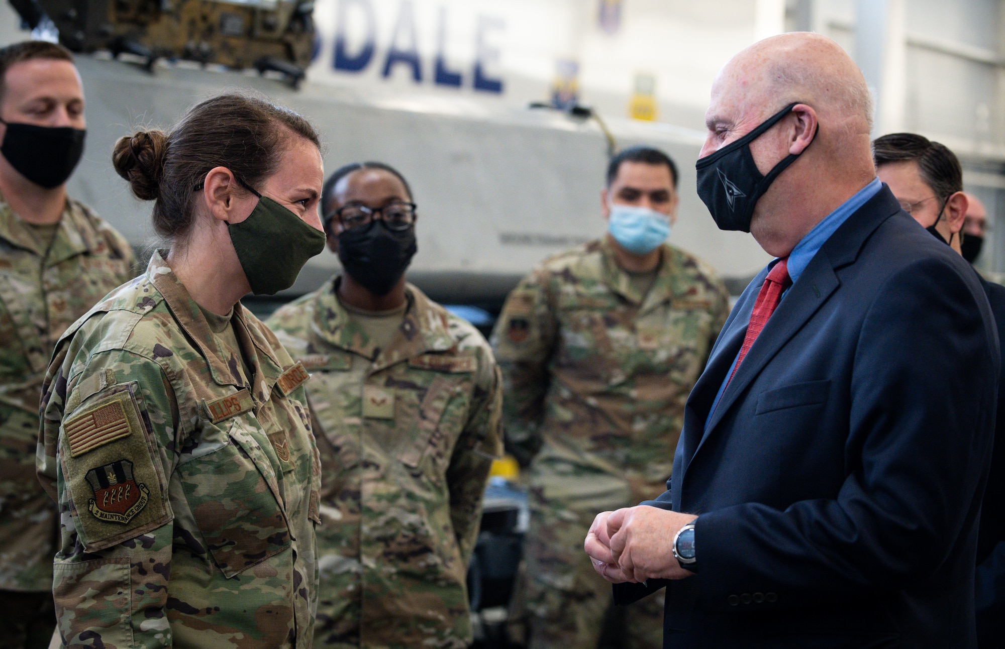 Tech. Sgt. Marcella Phillips, 2nd Maintenance Group load standardization crew member, is presented a coin from Honorable John P. Roth, acting Secretary of the Air Force, during a tour at Barksdale Air Force Base, Louisiana, April 6, 2021. The tour consisted of a B-52H Stratofortress with briefings from weapons load crew, crew chiefs and air crew. (U.S. Air Force photo by Senior Airman Max Miller)