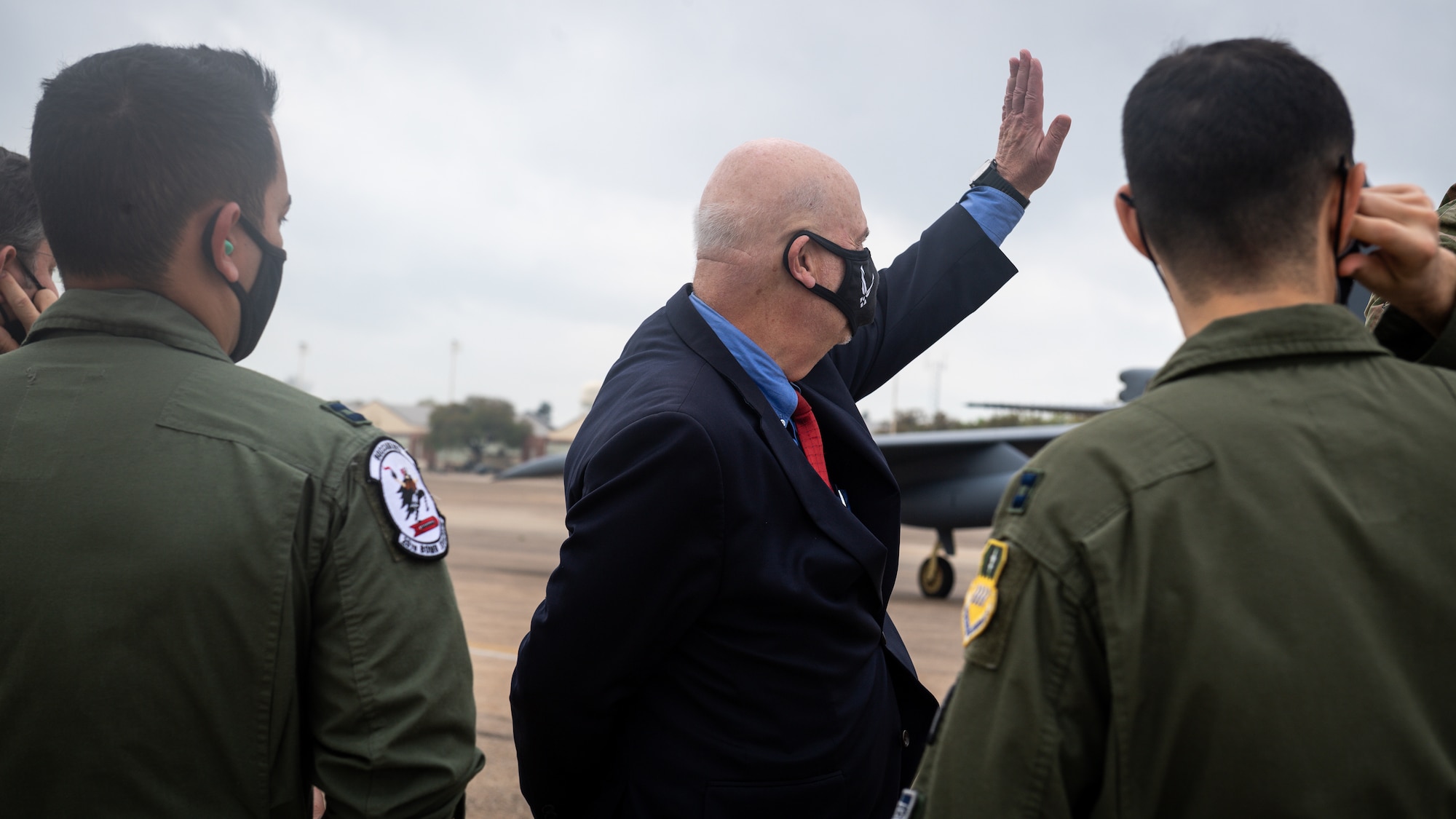 Honorable John P. Roth, acting Secretary of the Air Force, waves at a passing B-52H Stratofortress during a tour at Barksdale Air Force Base, Louisiana, April 6, 2021. The tour consisted of a B-52 with briefings from weapons load crew, crew chiefs and air crew. (U.S. Air Force photo by Senior Airman Max Miller)
