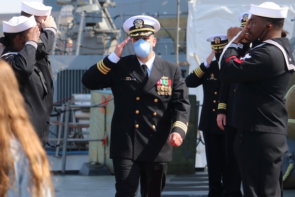 PORTSMOUTH, Va. (April 9, 2021) – Cmdr. Sam T. Sareini is piped aboard before the Arleigh Burke-class guided-missile destroyer USS Nitze’s change of command ceremony. Sareini was relieved by Cmdr. Donald J. Curran III during the ceremony. (U.S. Navy photo by Ens. William Fong/Released)