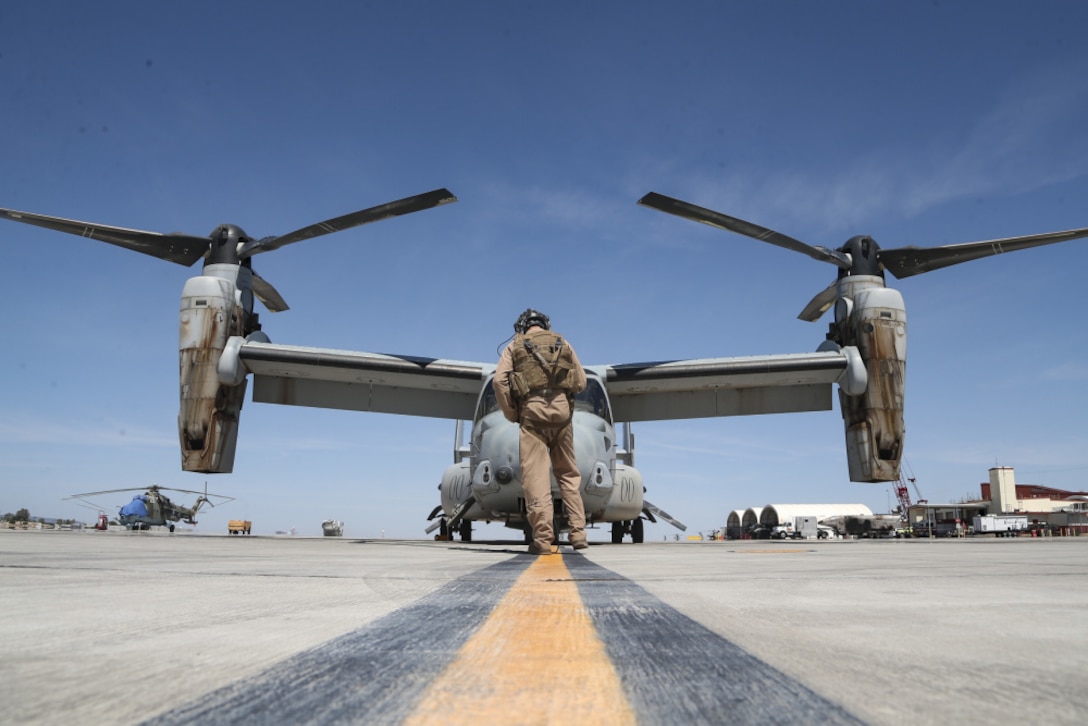 U.S. Marine Corps Sgt. Jordan Hasberger an MV-22B Osprey crew chief, with Marine Medium Tiltrotor Squadron 262, Marine Aircraft Group 36, 1st Marine Aircraft Wing conducts preflight checks, during a day gun range in support of Weapons and Tactics Instructor course 2-21, at Marine Corps Air Station Yuma, Ariz., April 6, 2021. The WTI course is a seven-week training event hosted by Marine Aviation Weapons and Tactics Squadron One, providing standardized advanced tactical training and certification of unit instructor qualifications to support Marine aviation training and readiness, and assists in developing and employing aviation weapons and tactics.