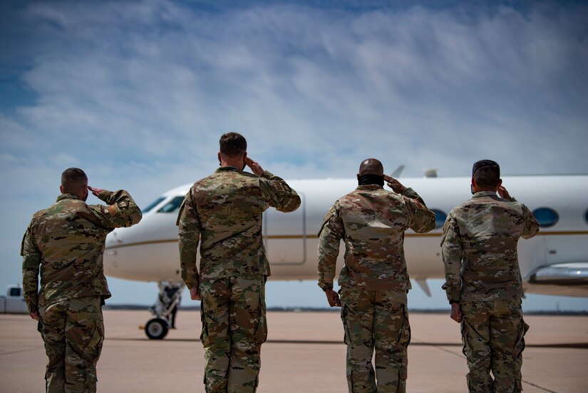 Leadership from the 317th Airlift Wing and 7th Bomb Wing salute a C-37A at Dyess Air Force Base, Texas, April 6, 2021. Acting Secretary of the Air Force John Roth visited Dyess AFB during a tour of three U.S. Air Force Global Strike Command bases. (U.S. Air Force photo by Airman 1st Class Colin Hollowell)