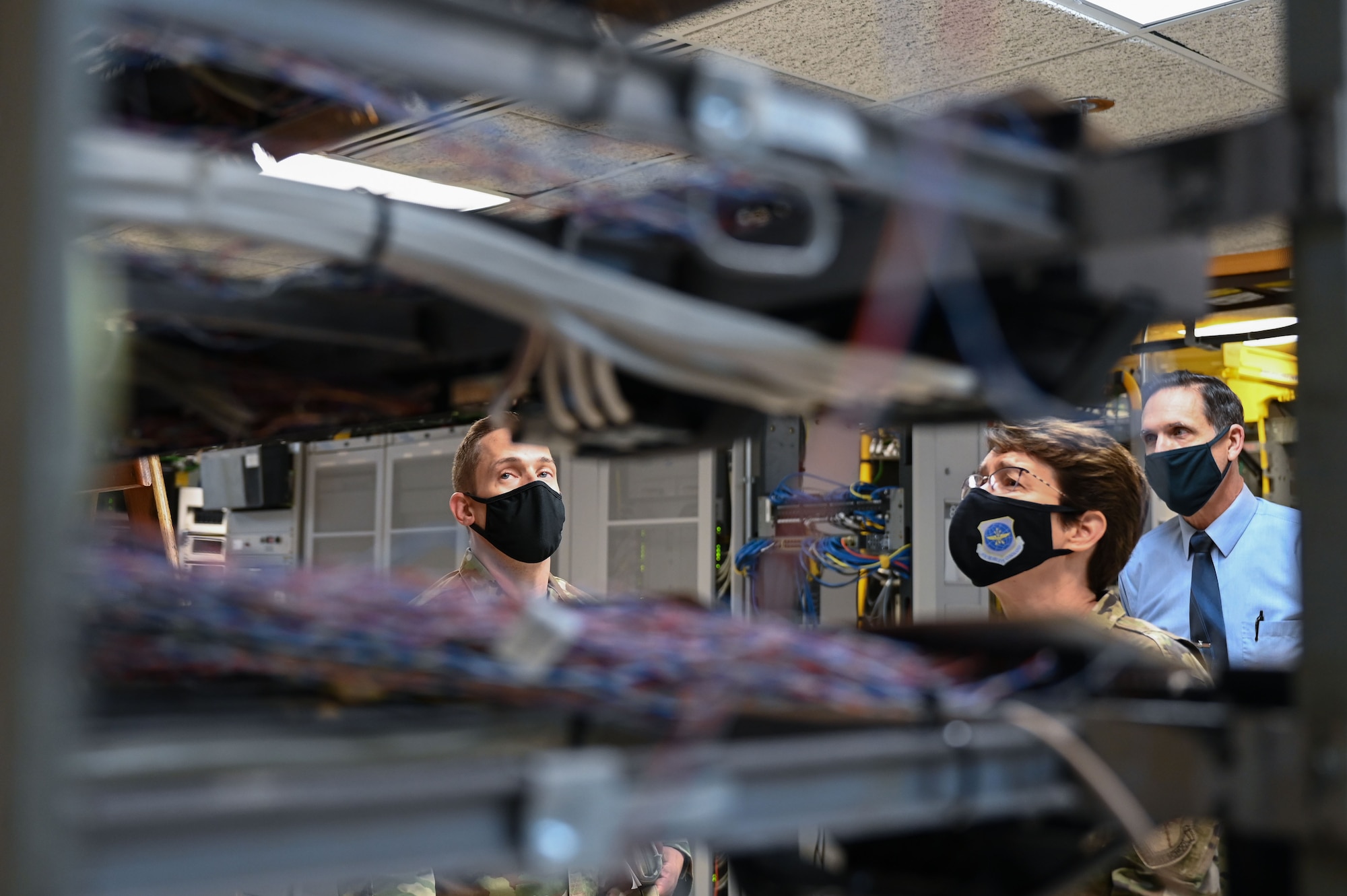 Airmen look at cables.